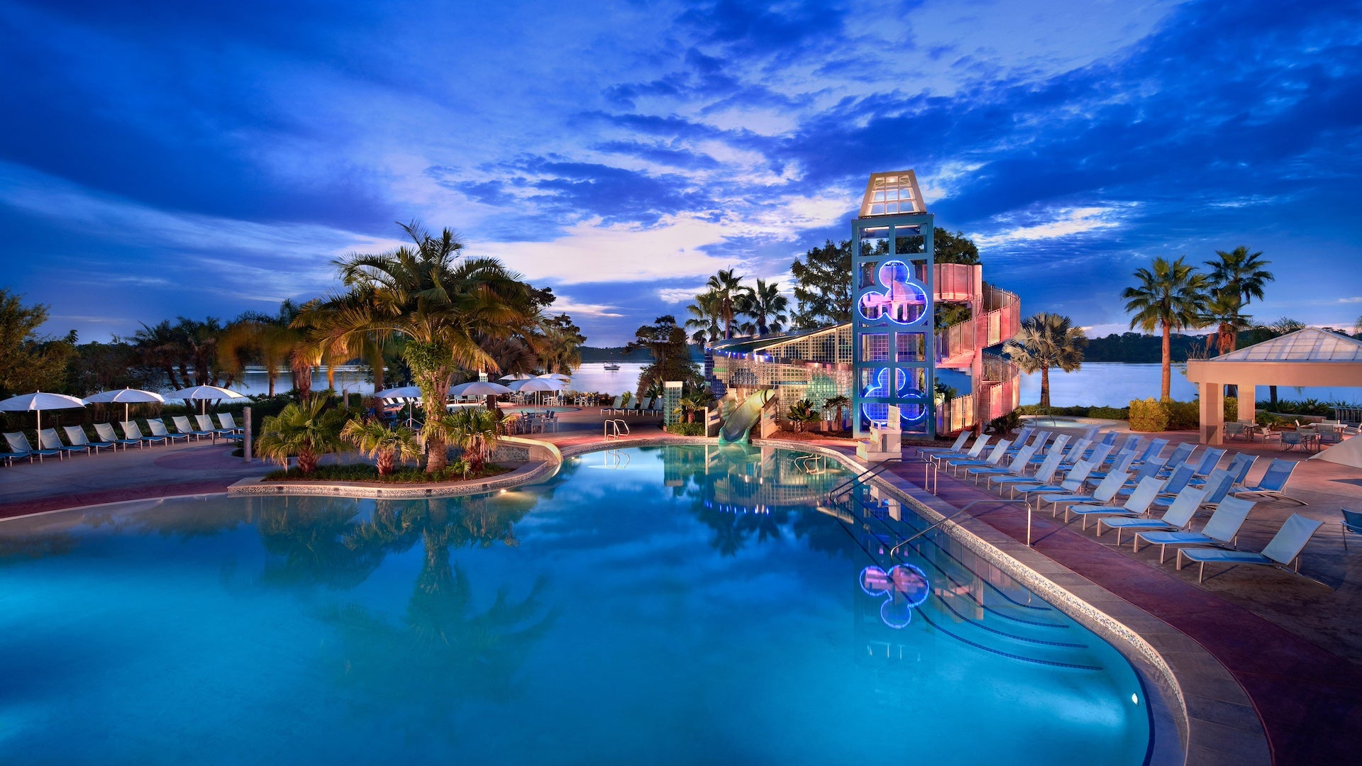 Tropical themed pool at dusk that the Contemporary resort